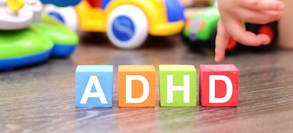 image of child playing with letter blocks spelling out the word ADHD.